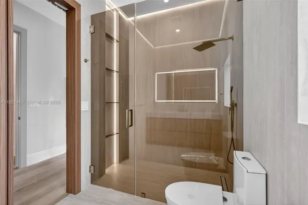 a front view of a house with swimming pool and porch