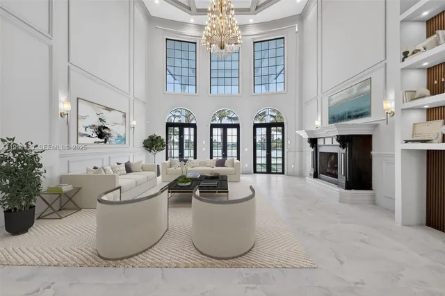 a view of a dining room with furniture a chandelier and wooden floor