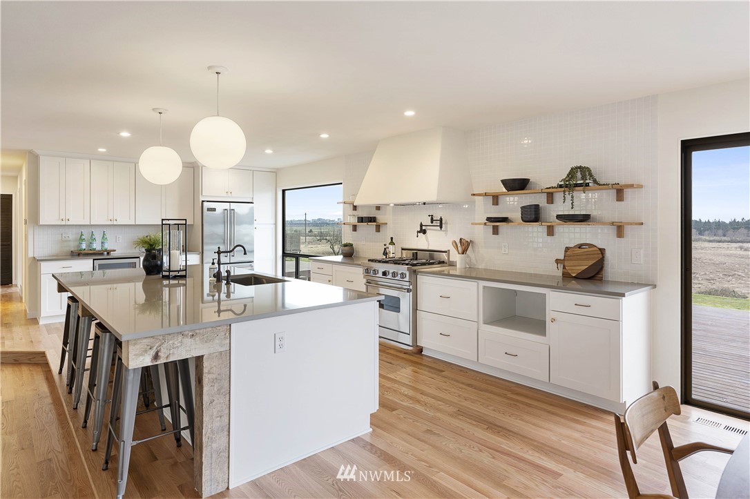 6829 Skipley Road Snohomish, WA 98290 - Photo 8 of 26 a kitchen with white cabinets and stainless steel appliances