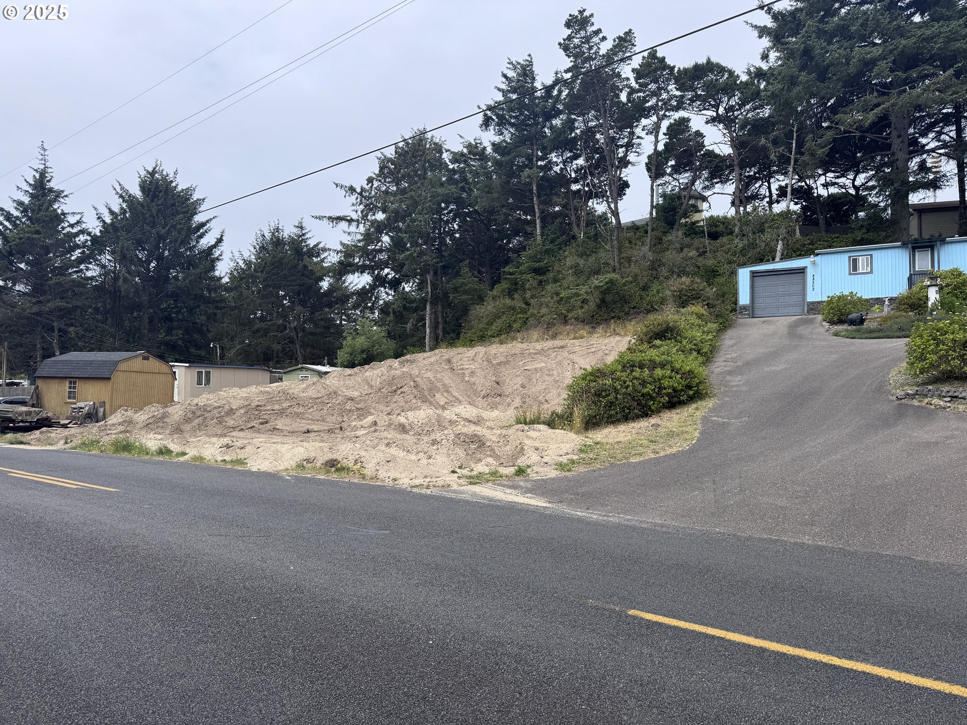 1695947 4th Florence, OR 97439 - Photo 3 of 4 a street view covered with tall trees