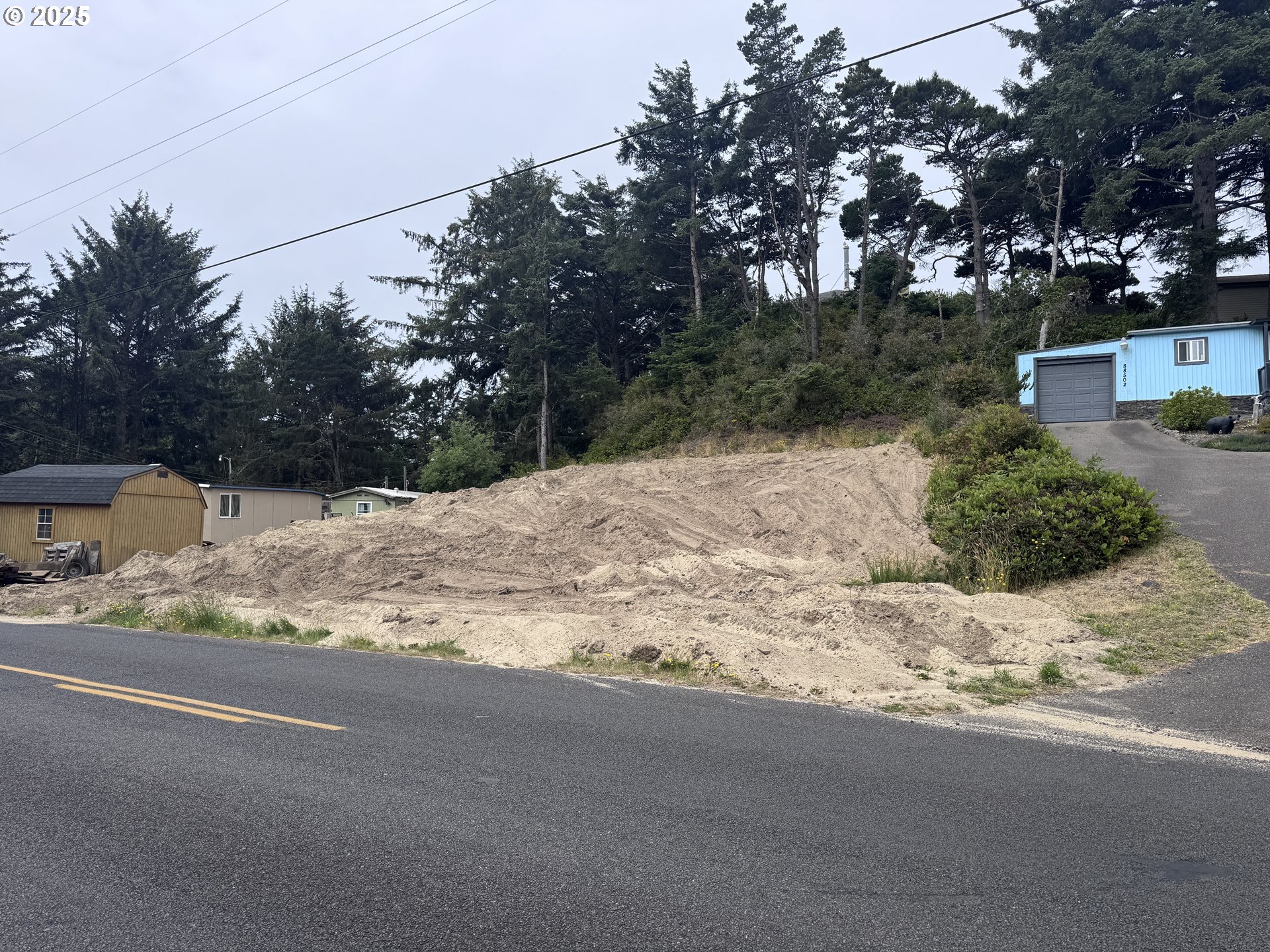1695947 4th Florence, OR 97439 - Photo 4 of 4 a backyard of a house with large trees and plants