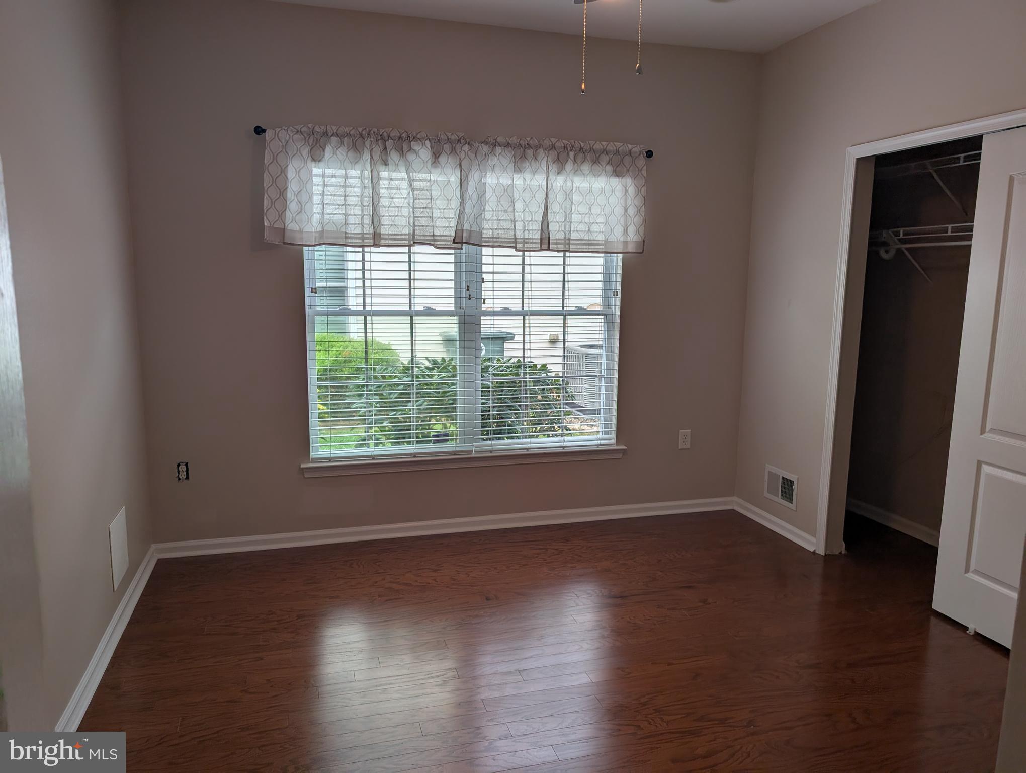 302 Gosling Way Glassboro, NJ 08028 - Photo 11 of 13 an empty room with wooden floor and windows