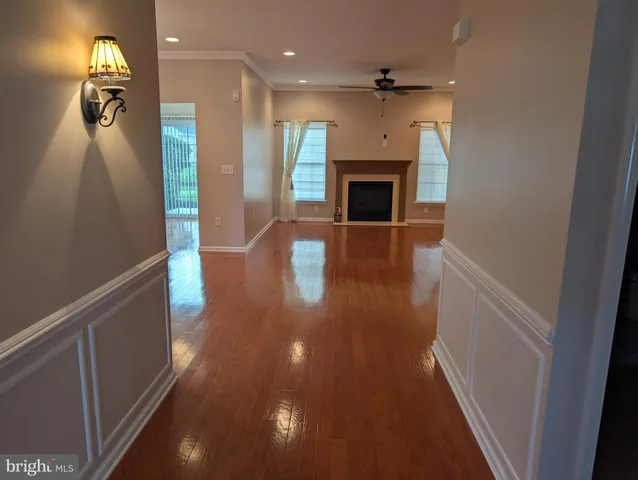 wooden floor in an empty room with a fireplace