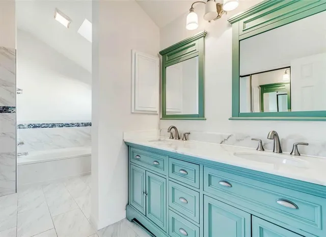 a bathroom with a double vanity sink mirror and