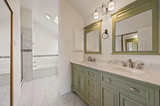 a bathroom with a double vanity sink mirror and