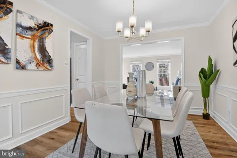 a view of a dining room with furniture and a chandelier