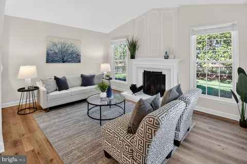 a living room with furniture and a dining table