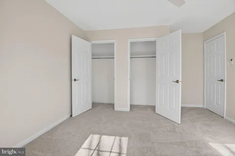 a spacious bedroom with a bed and a chandelier