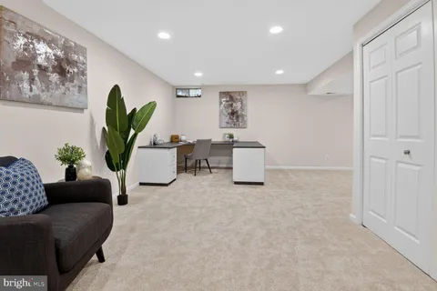 a living room with furniture a air conditioner vent and a window