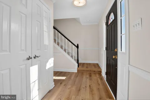 a view of a hallway with wooden floor and dining room