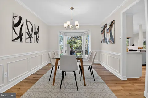 a view of a dining room with furniture wooden floor and chandelier