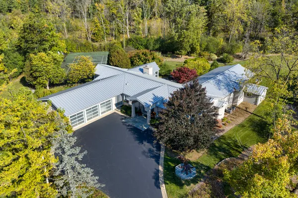 an aerial view of a house with a yard and trees