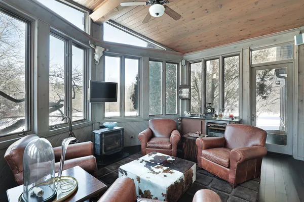 a living room with furniture and floor to ceiling windows