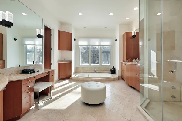 a bathroom with a tub sink and mirror
