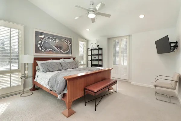 a spacious bedroom with a bed and a couch