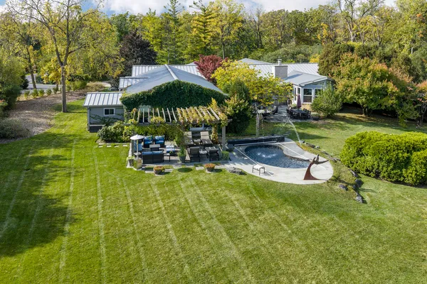 a swimming pool with outdoor seating and yard