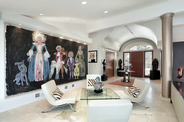 a living room with furniture and a painting
