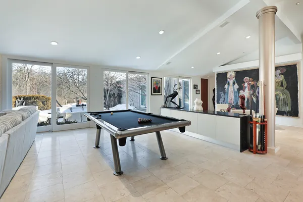 a living room with furniture a table and a large window