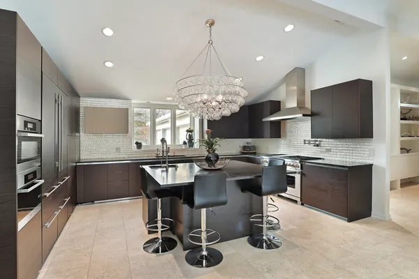 a kitchen with kitchen island granite countertop stainless steel appliances a sink stove and refrigerator