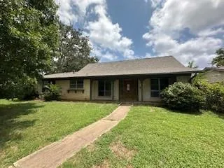 a front view of a house with a yard and porch