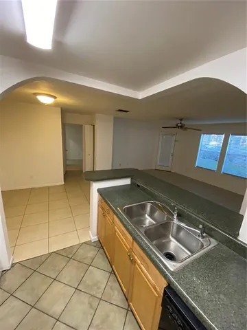 a kitchen that has a sink and a stove