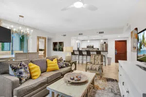 a living room with furniture and view of kitchen