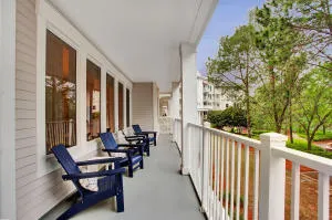 a balcony with chairs and with outdoor seating