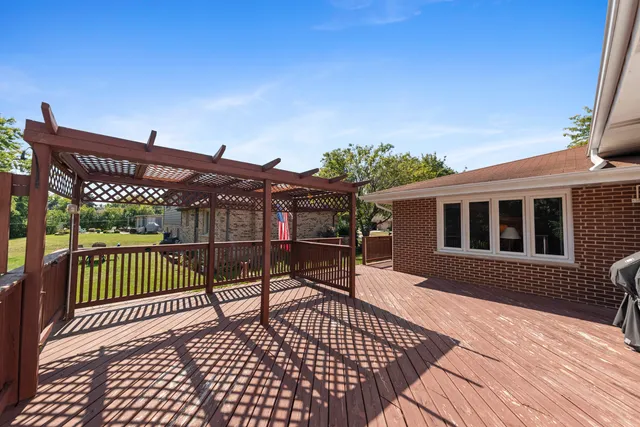a view of a house with a wooden deck