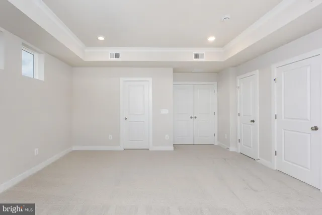 an empty room with a empty space and windows