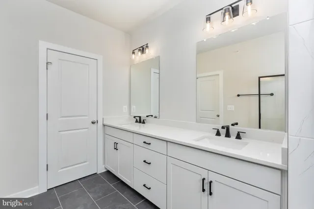 a bathroom with double sink and a mirror
