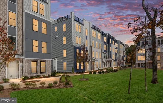 front view of an apartment building with a yard