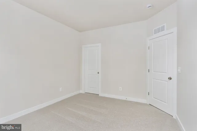 a bathroom with a sink mirror toilet and next to a window