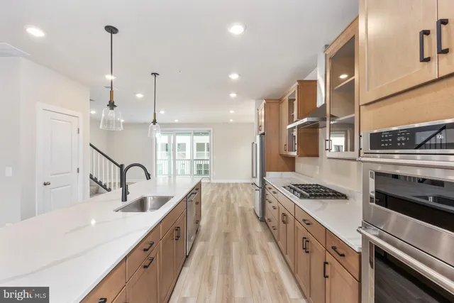 a kitchen with stainless steel appliances a sink stove and refrigerator