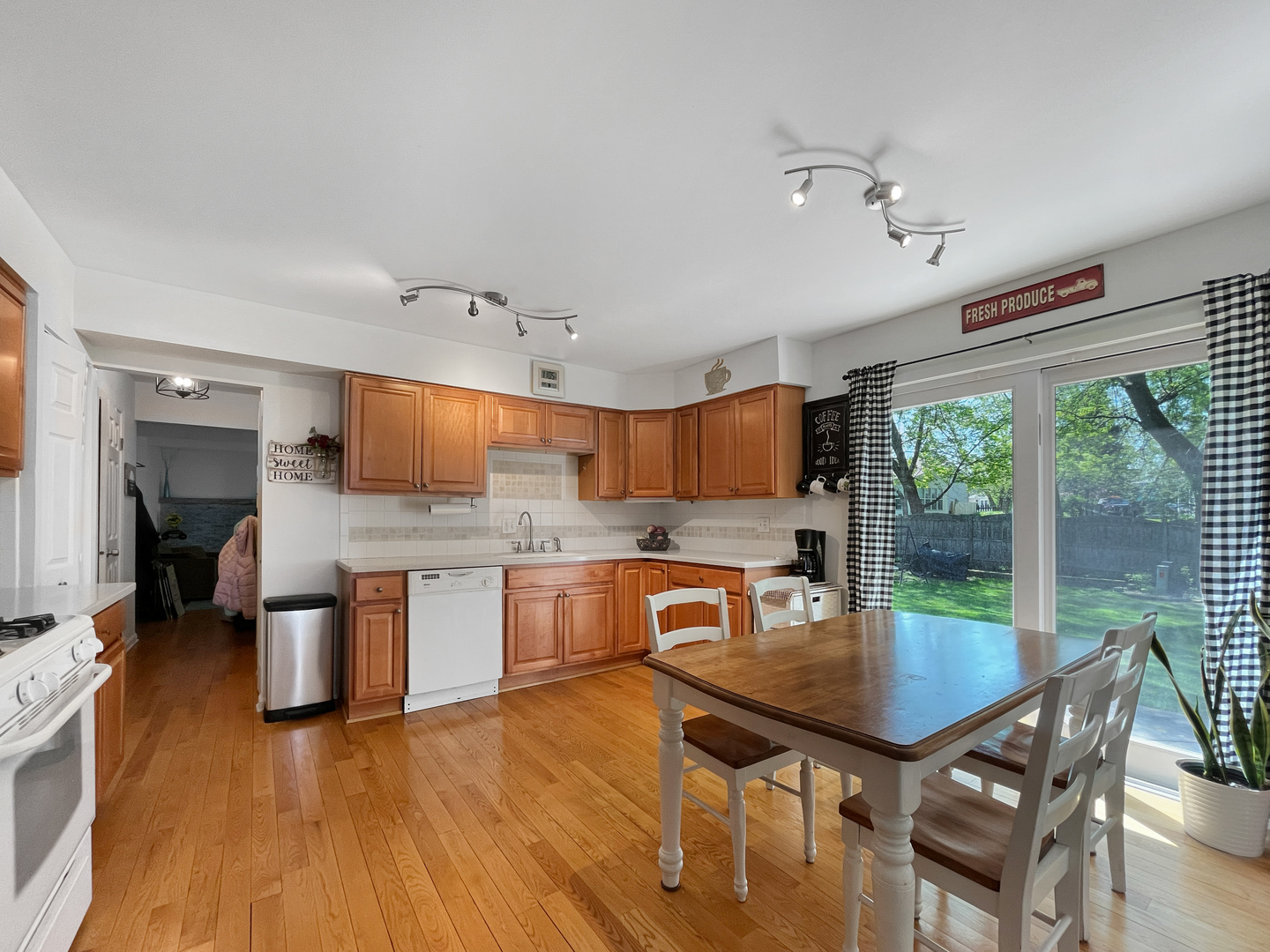 323 West Golf Road Libertyville, IL 60048 - Photo 3 of 10 a kitchen with a table chairs microwave and cabinets