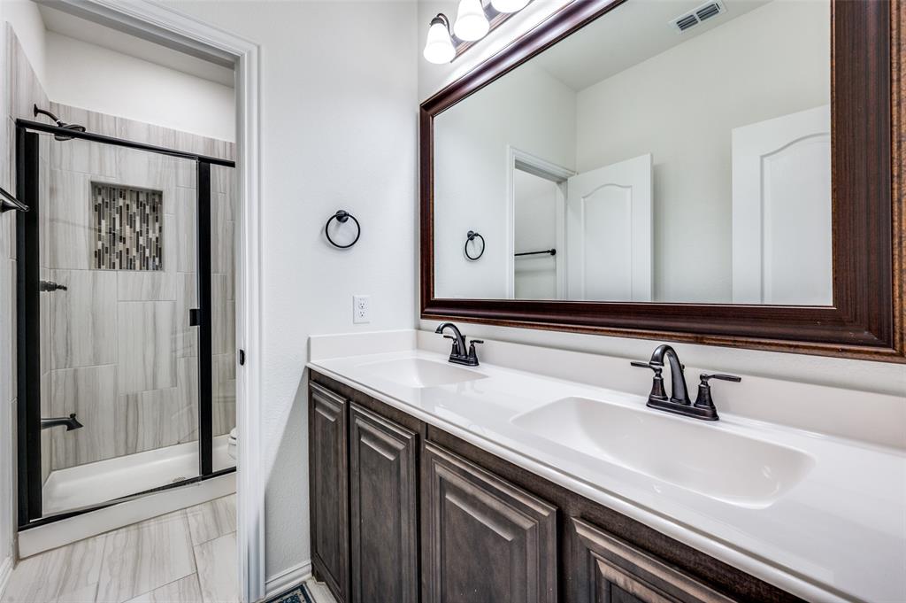 1616 George Lane Little Elm, TX 75068 - Photo 15 of 28 a bathroom with a sink and a mirror