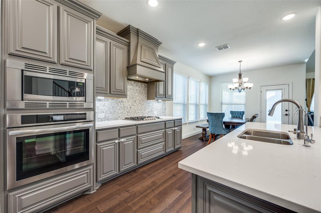 1616 George Lane Little Elm, TX 75068 - Photo 6 of 28 a kitchen with stainless steel appliances a stove microwave and sink