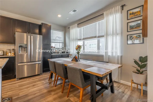 a living room with furniture kitchen view and large windows