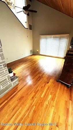 a living room with furniture fireplace and large windows