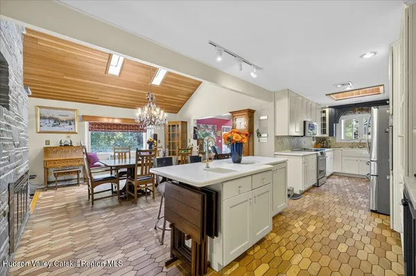 a kitchen with stainless steel appliances granite countertop a stove and a dining table
