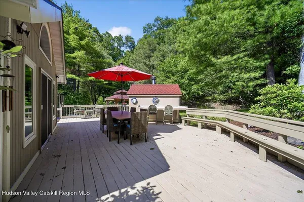 a balcony with furniture and wooden floor