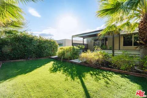 a view of yard with swimming pool and outdoor seating