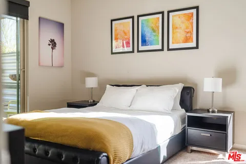 a bedroom with two beds and a large window