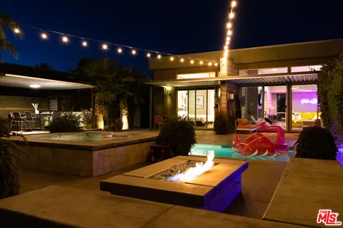 a view of a swimming pool with a table and chairs