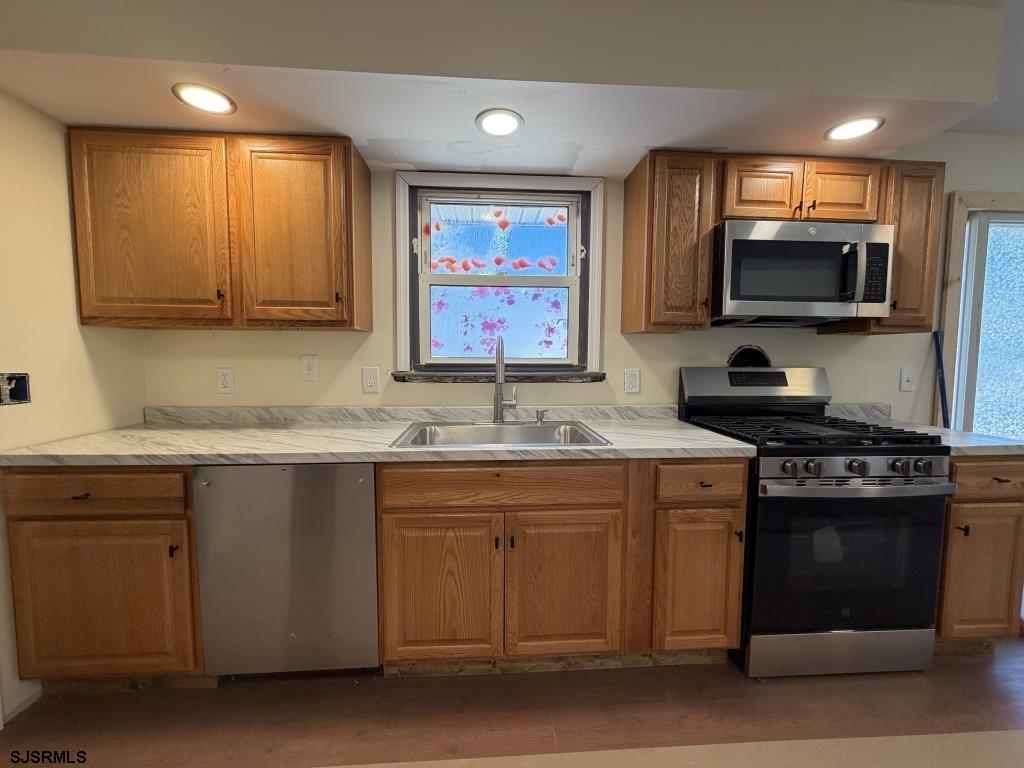 322 West Nicholson Road Mount Ephraim, NJ 08059 - Photo 11 of 47 a kitchen with a sink stove top oven and microwave