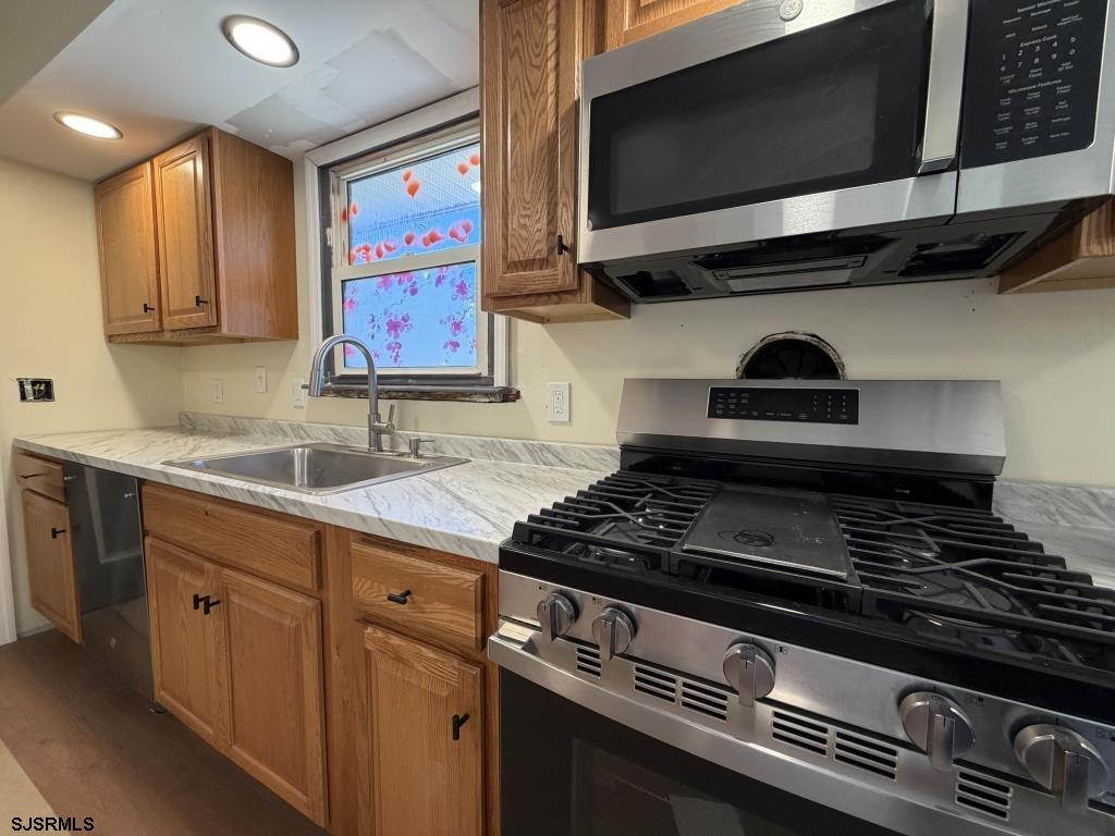 322 West Nicholson Road Mount Ephraim, NJ 08059 - Photo 12 of 47 a kitchen with stainless steel appliances granite countertop a stove and a microwave