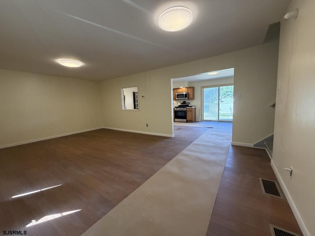 322 West Nicholson Road Mount Ephraim, NJ 08059 - Photo 15 of 47 an empty room with wooden floor and windows