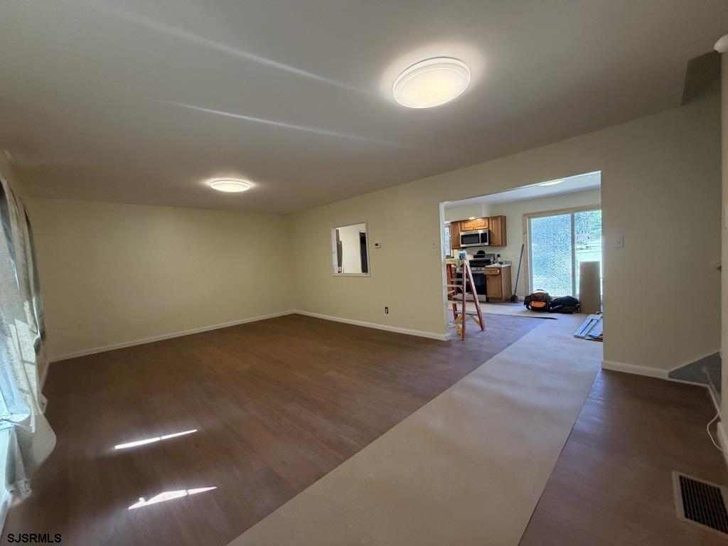 322 West Nicholson Road Mount Ephraim, NJ 08059 - Photo 6 of 47 an empty room with wooden floor and windows