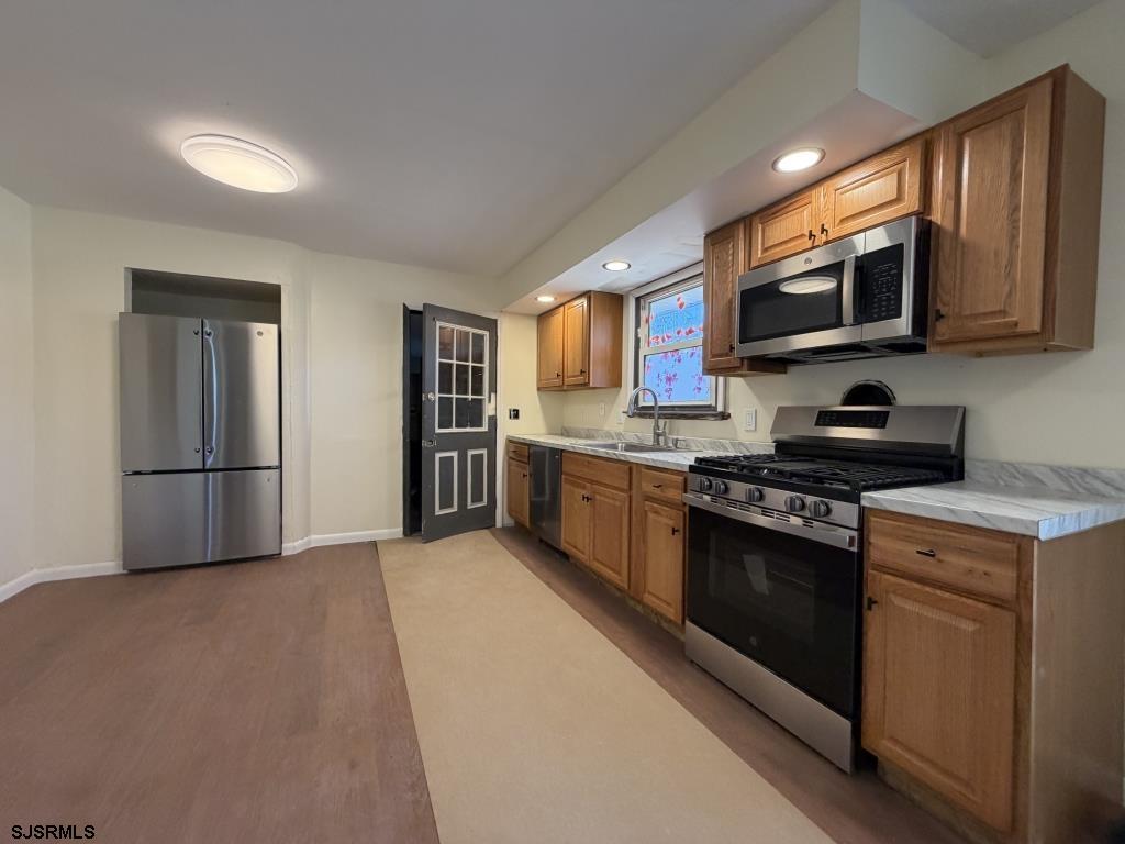 322 West Nicholson Road Mount Ephraim, NJ 08059 - Photo 10 of 47 a kitchen with stainless steel appliances granite countertop a stove a refrigerator and a microwave