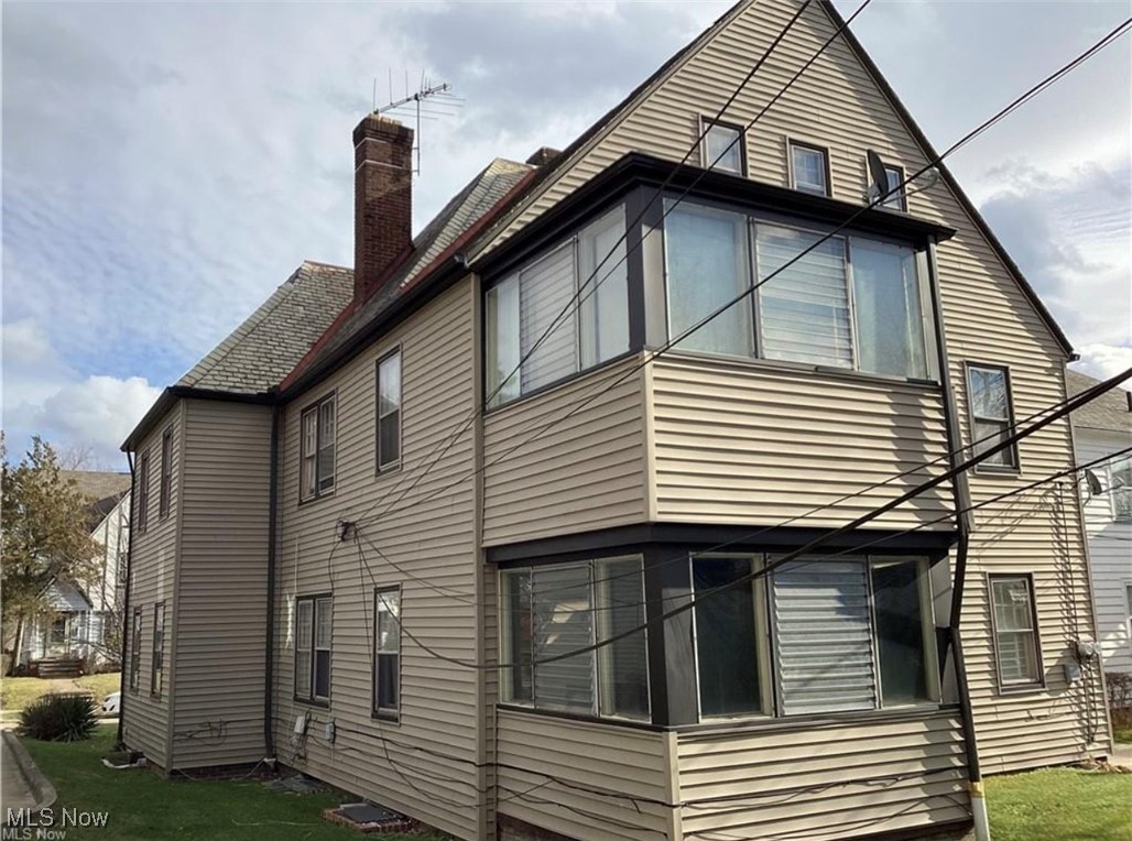 3362 Sutton Road Cleveland, OH 44120 - Photo 2 of 43 View of property exterior with a chimney and a lawn