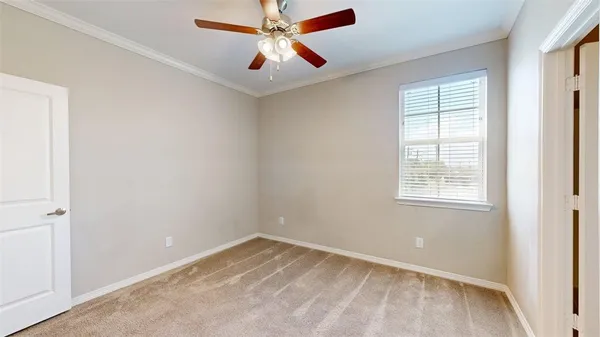 a view of an empty room with a ceiling fan